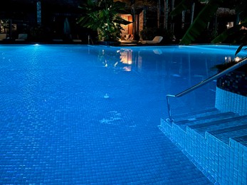 Photo of Beautiful view of swimming pool with clear water at night