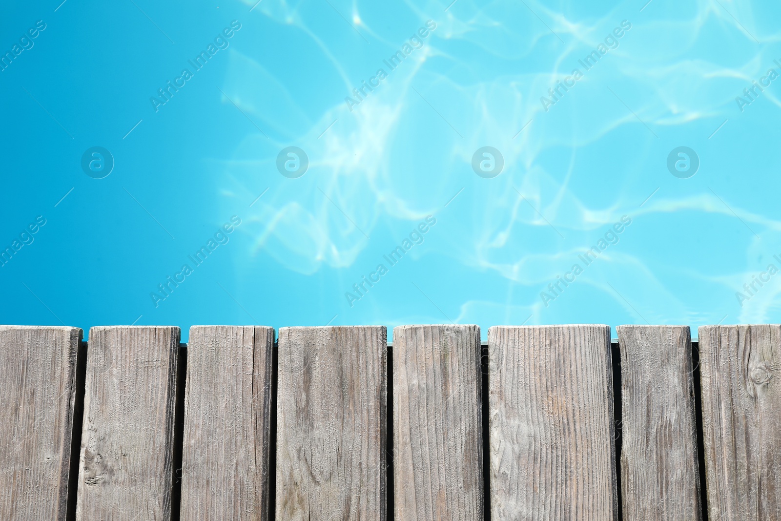 Photo of Wooden desk near outdoor swimming pool at resort