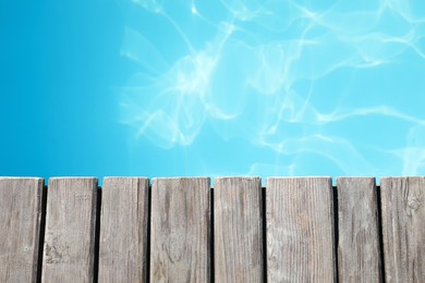 Photo of Wooden desk near outdoor swimming pool at resort