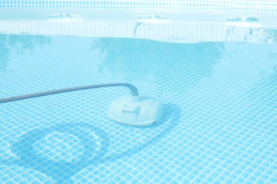 Photo of One robotic cleaner in swimming pool outdoors