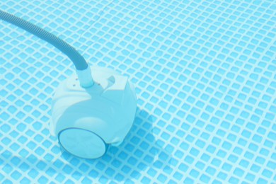 One robotic cleaner in swimming pool outdoors, space for text