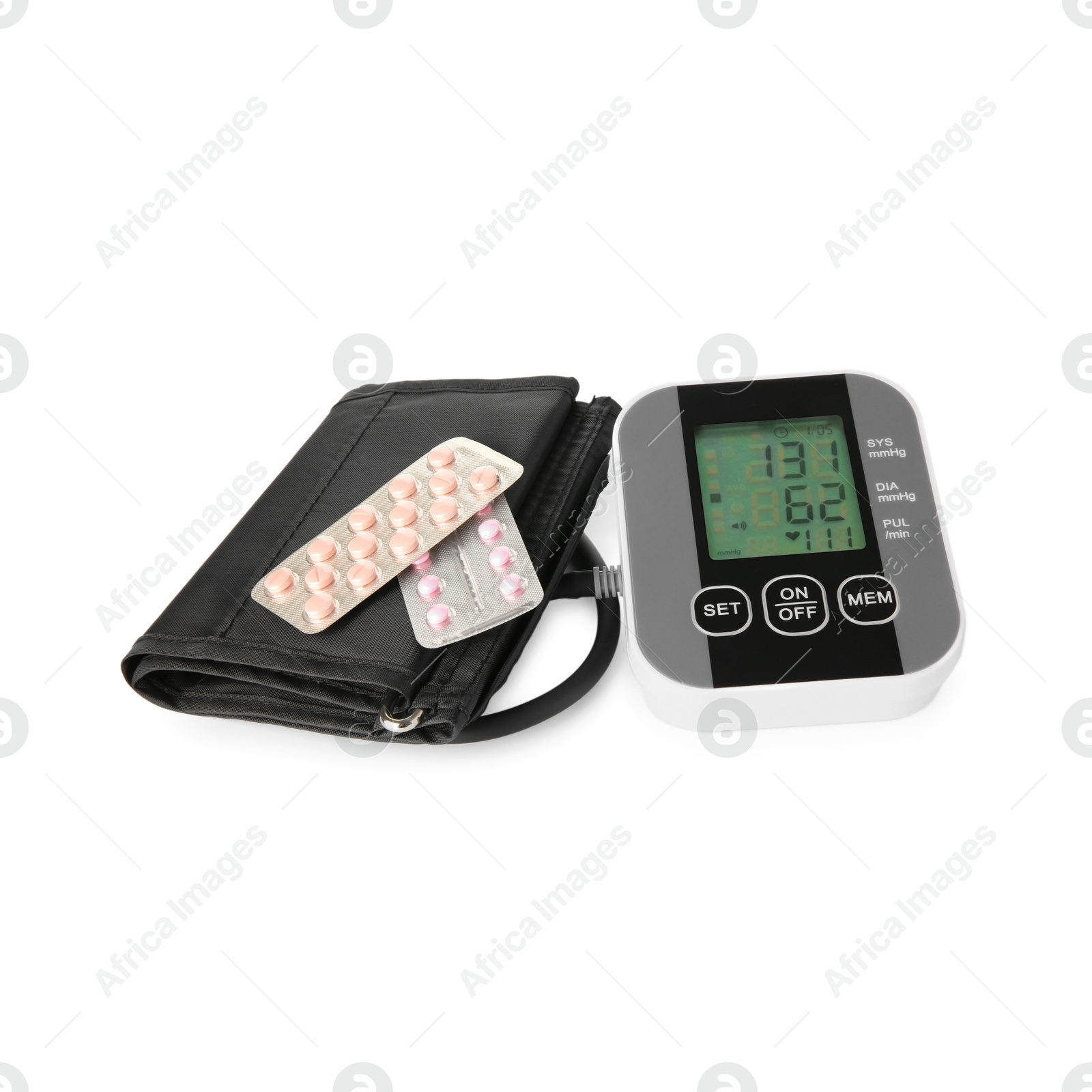 Photo of Blood pressure measuring device and pill blisters isolated on white