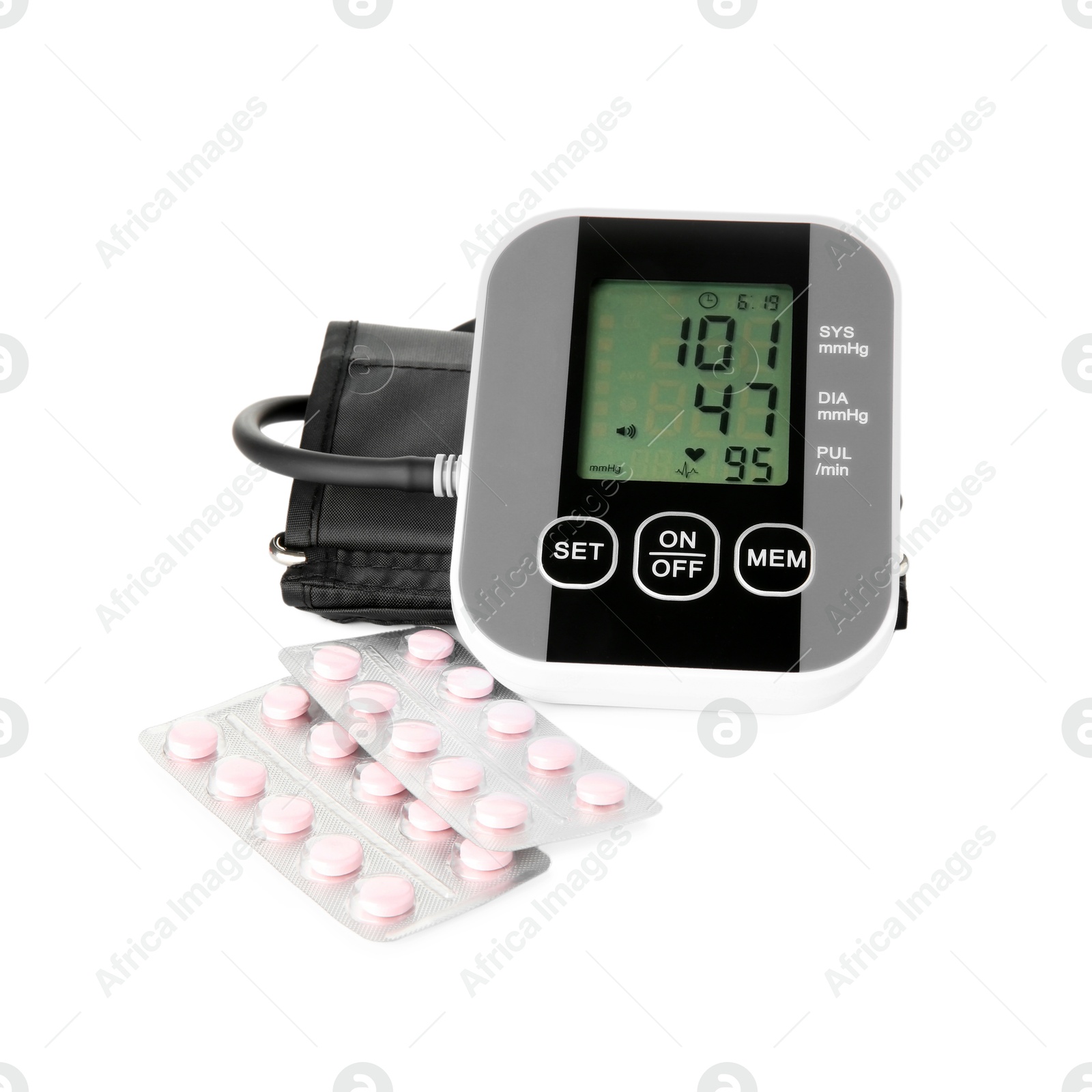 Photo of Blood pressure measuring device and pill blisters isolated on white