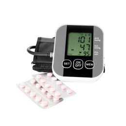 Blood pressure measuring device and pill blisters isolated on white