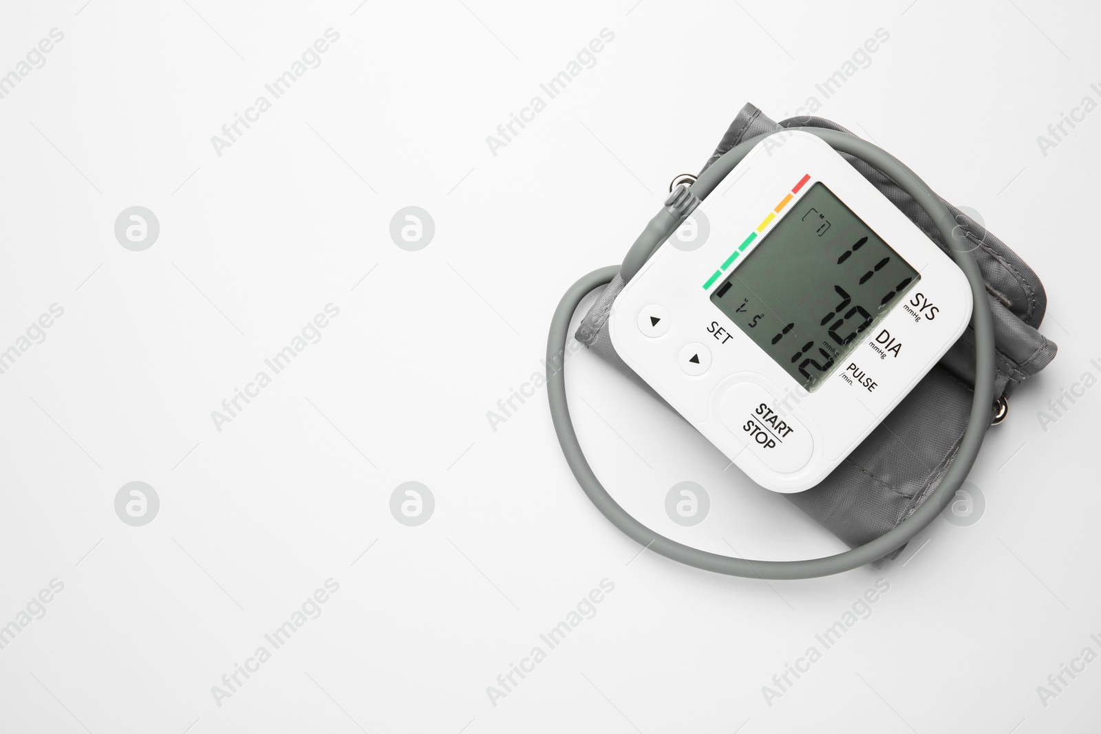 Photo of Blood pressure measuring device on light grey background, top view. Space for text