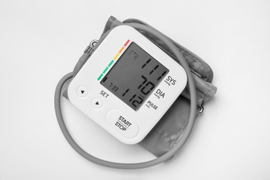 Blood pressure measuring device on light grey background, top view