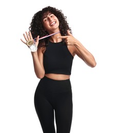 Happy winner pointing at her medals on white background