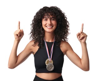 Happy winner with different medals pointing upwards on white background