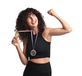 Happy winner with different medals showing muscles on white background