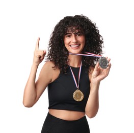 Photo of Happy winner with different medals pointing upwards on white background