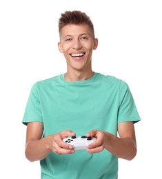 Happy young man playing video games with controller on white background