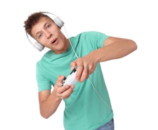 Photo of Young man in headphones playing video games with controller on white background