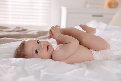 Cute little baby on bed at home