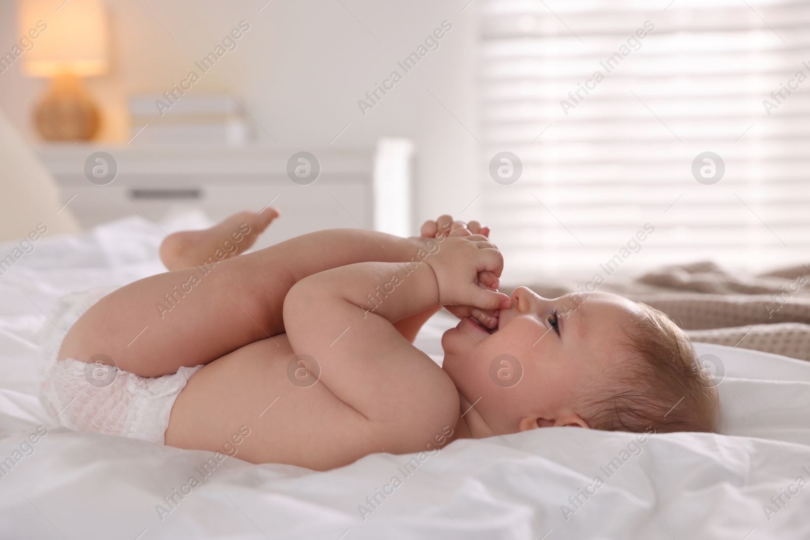 Photo of Cute little baby on bed at home