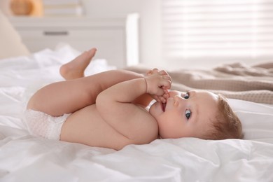 Photo of Cute little baby on bed at home