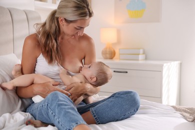 Mother breastfeeding her little baby at home