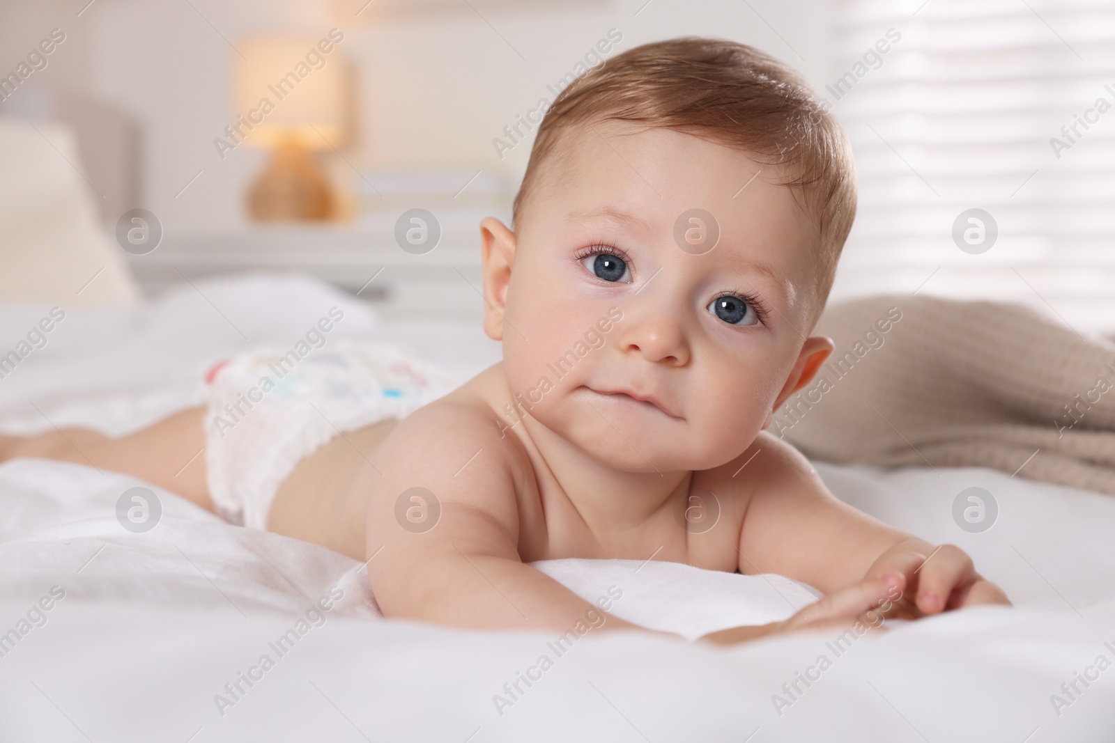 Photo of Cute little baby on bed at home