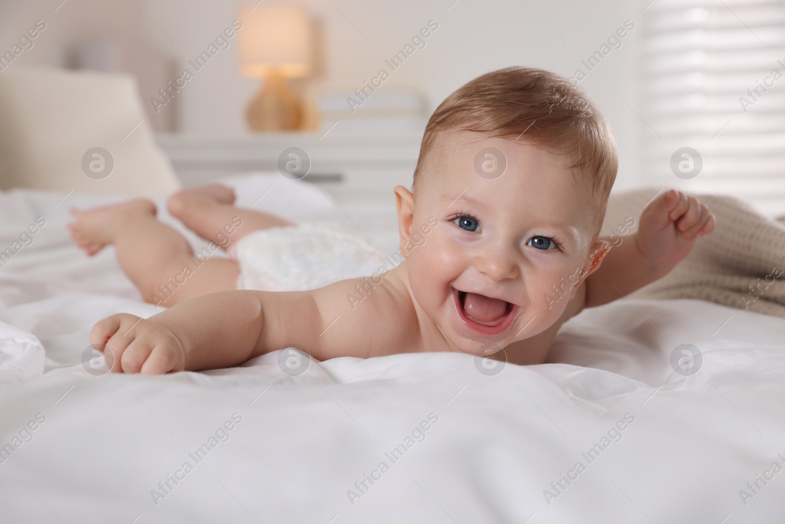 Photo of Cute little baby on bed at home