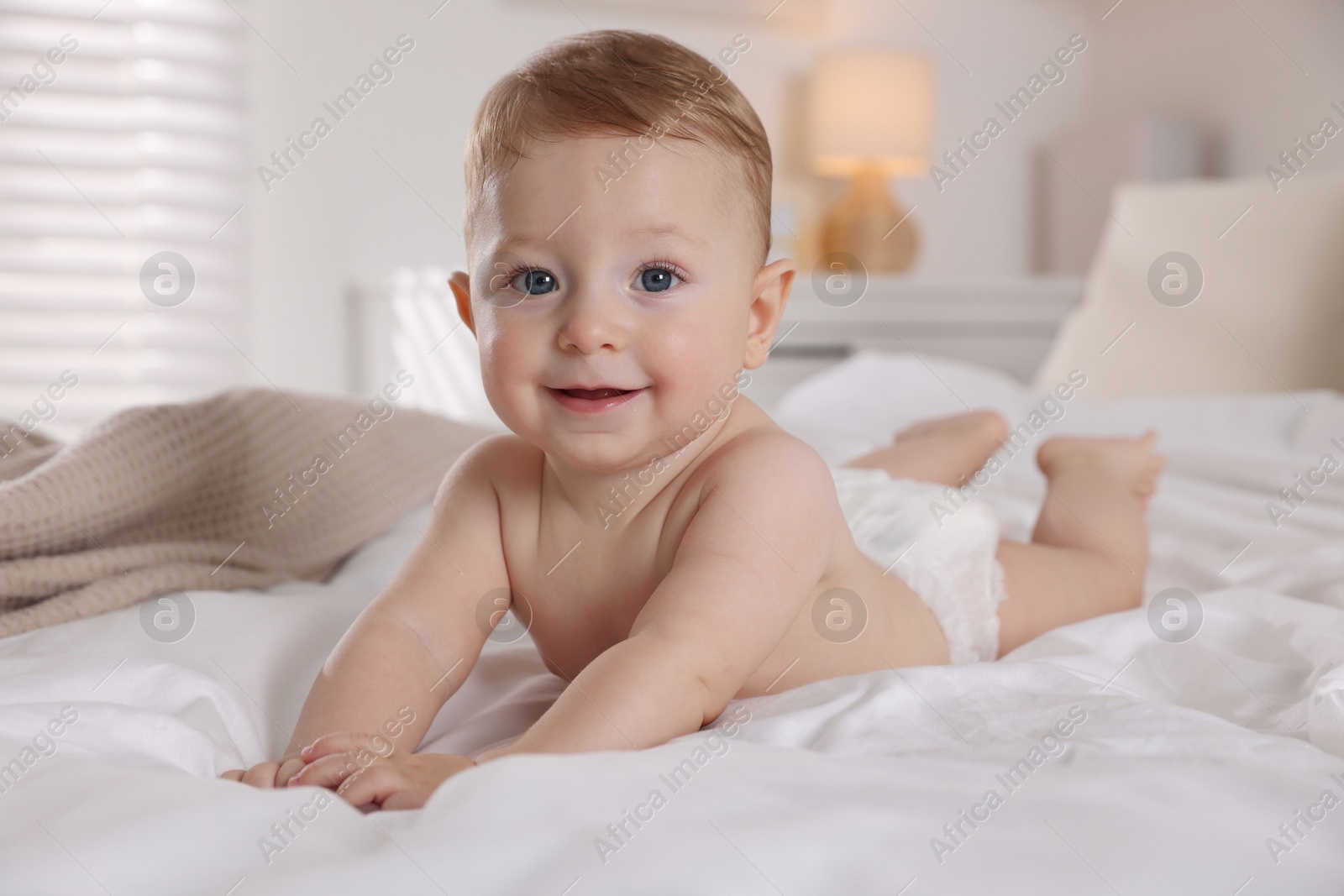 Photo of Cute little baby on bed at home