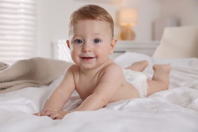 Cute little baby on bed at home