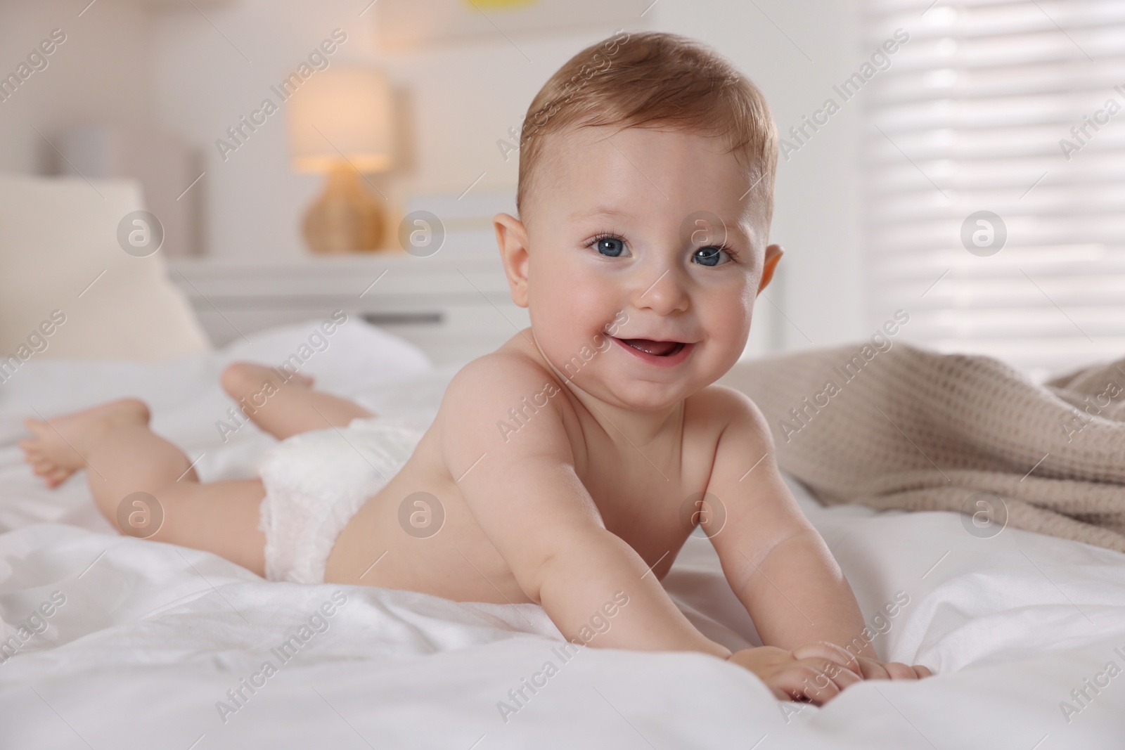 Photo of Cute little baby on bed at home