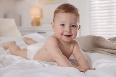 Cute little baby on bed at home