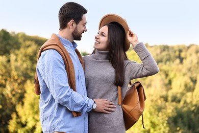 Beautiful couple spending time together outdoors on autumn day