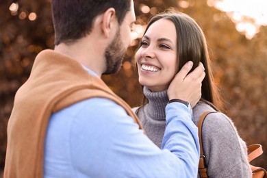 Photo of Beautiful couple spending time together outdoors on autumn day