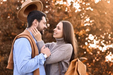 Beautiful couple spending time together outdoors on autumn day