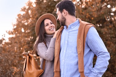 Photo of Beautiful couple spending time together outdoors on autumn day