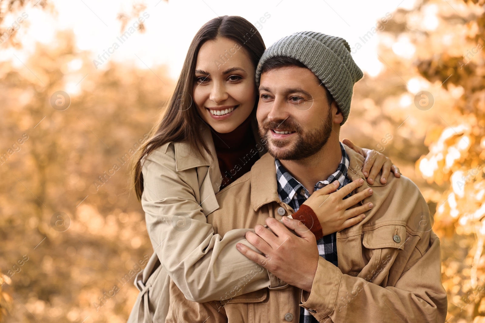 Photo of Beautiful happy couple hugging outdoors on autumn day