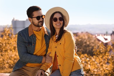 Beautiful couple in sunglasses outdoors on autumn day