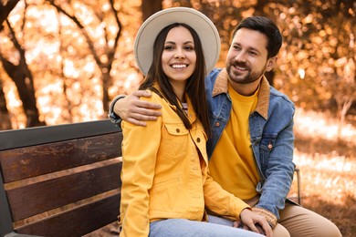 Beautiful couple spending time together in park on autumn day