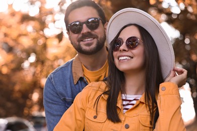 Beautiful couple in park on autumn day, selective focus