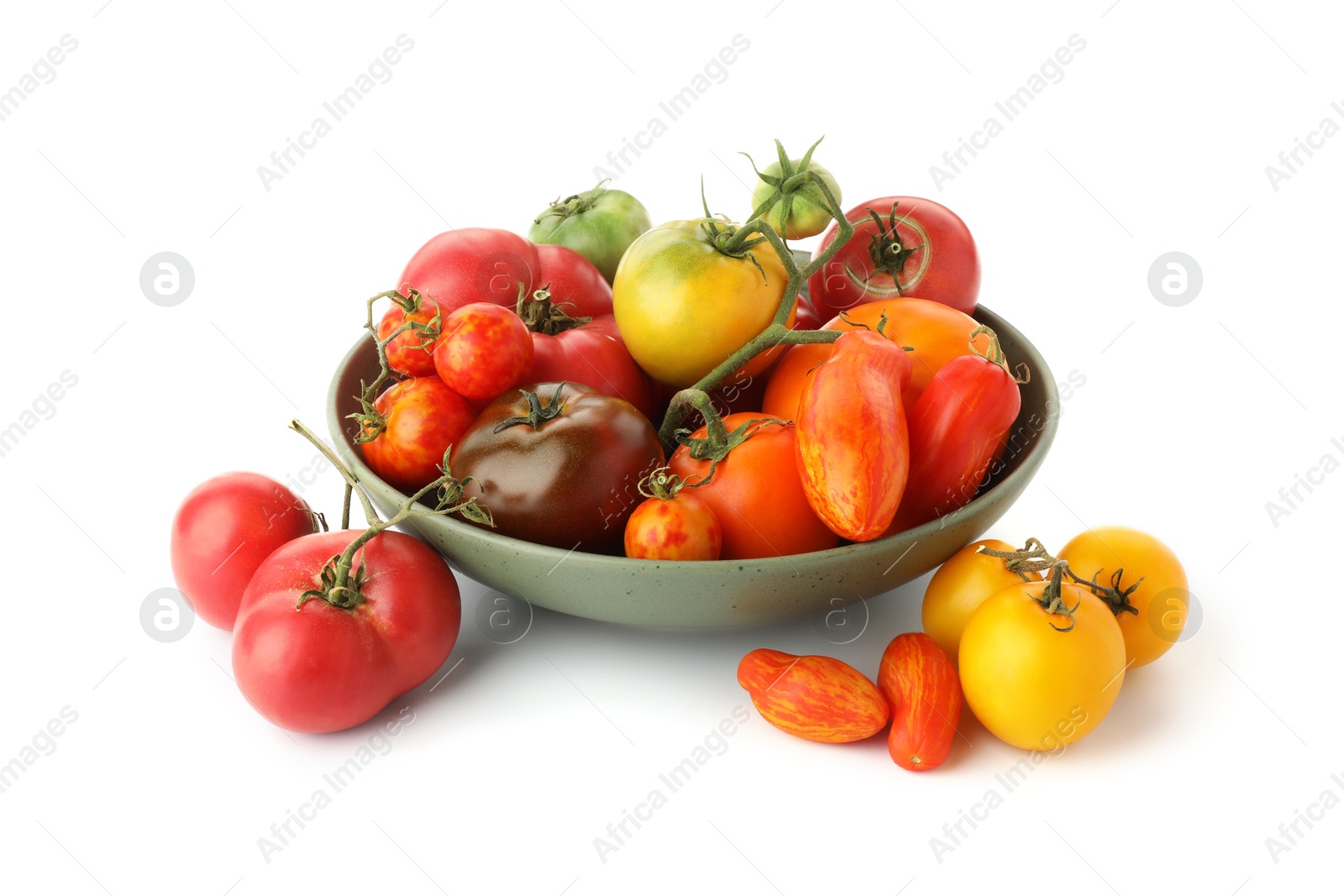 Photo of Different ripe tomatoes in bowl on white background