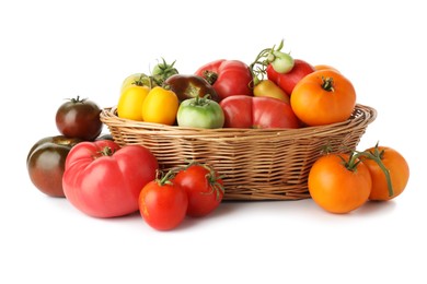 Photo of Different ripe tomatoes in basket on white background