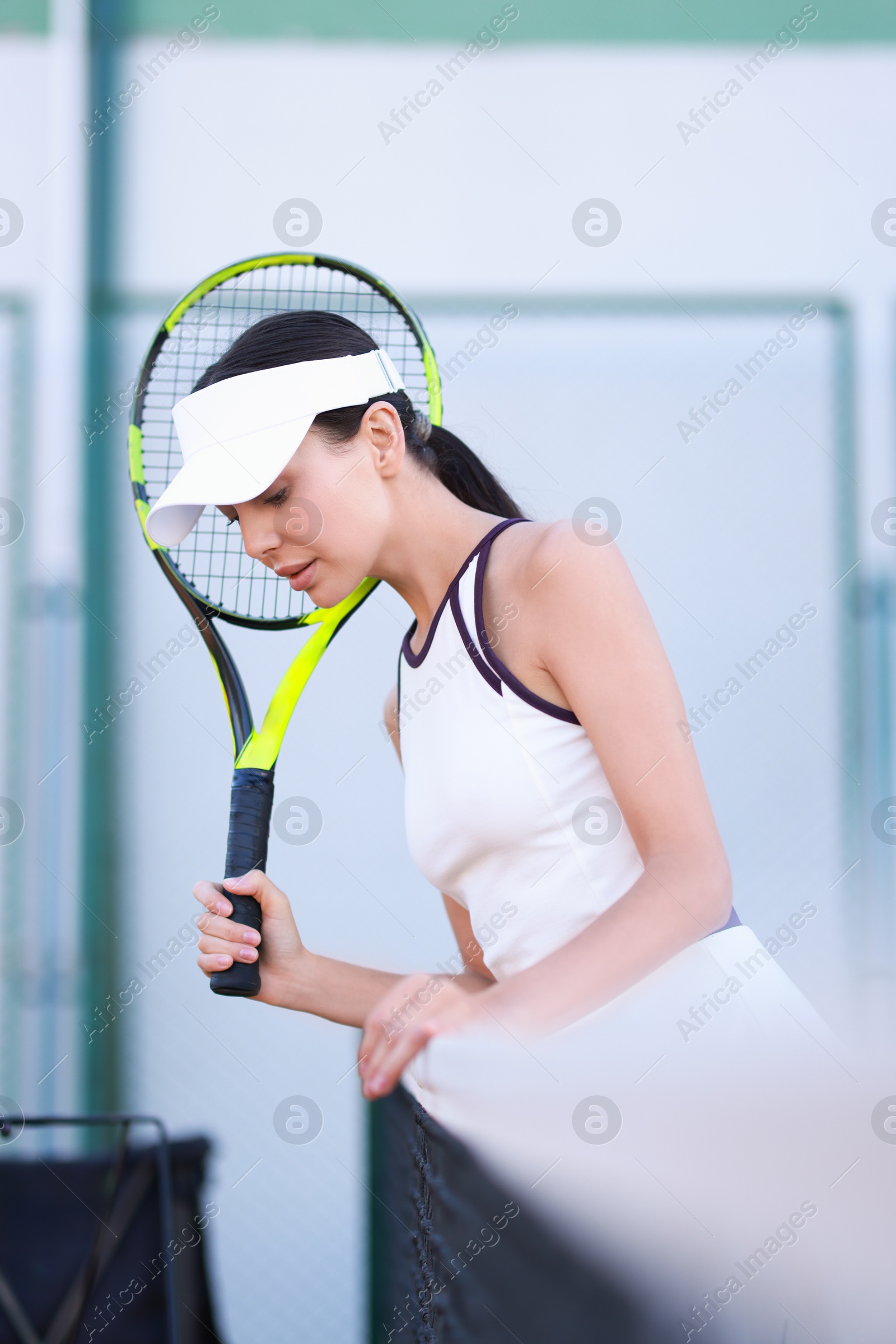 Photo of Beautiful woman with tennis racket on court