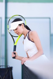 Photo of Beautiful woman with tennis racket on court