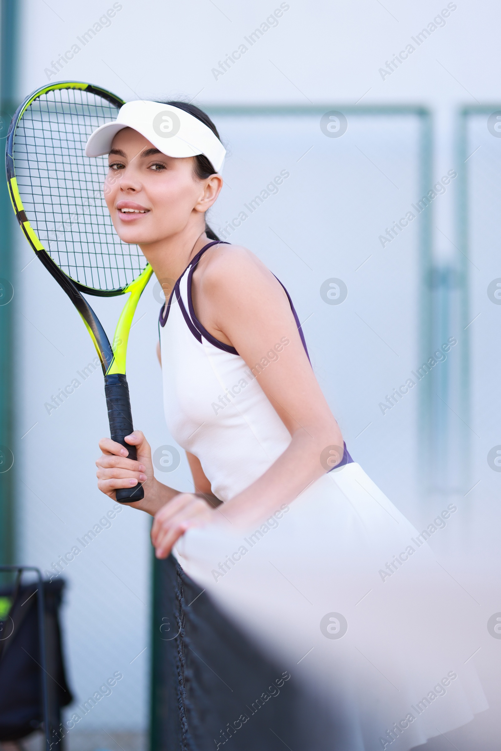 Photo of Beautiful woman with tennis racket on court