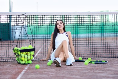 Photo of Beautiful woman in sportswear on tennis court