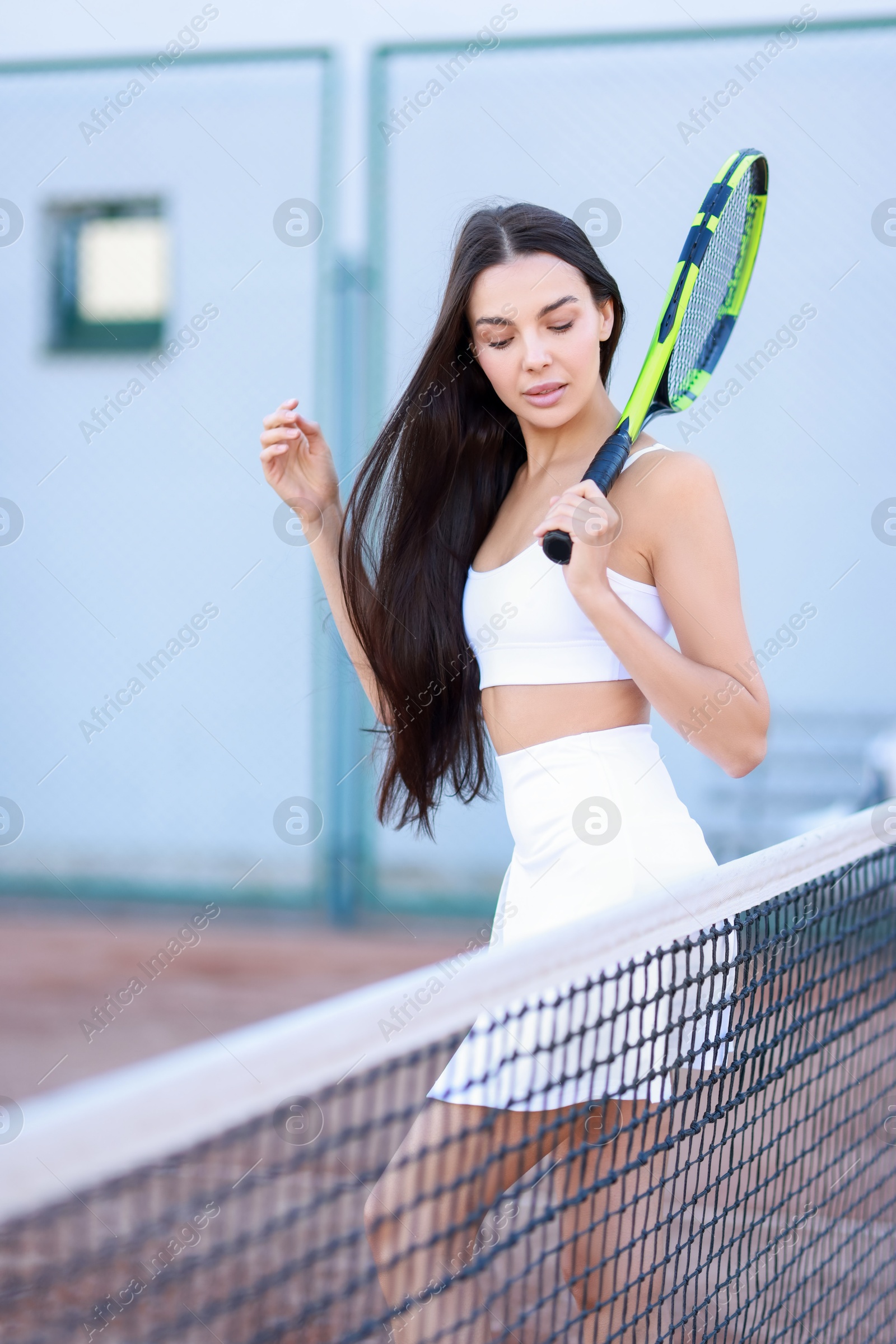 Photo of Beautiful woman with tennis racket on court