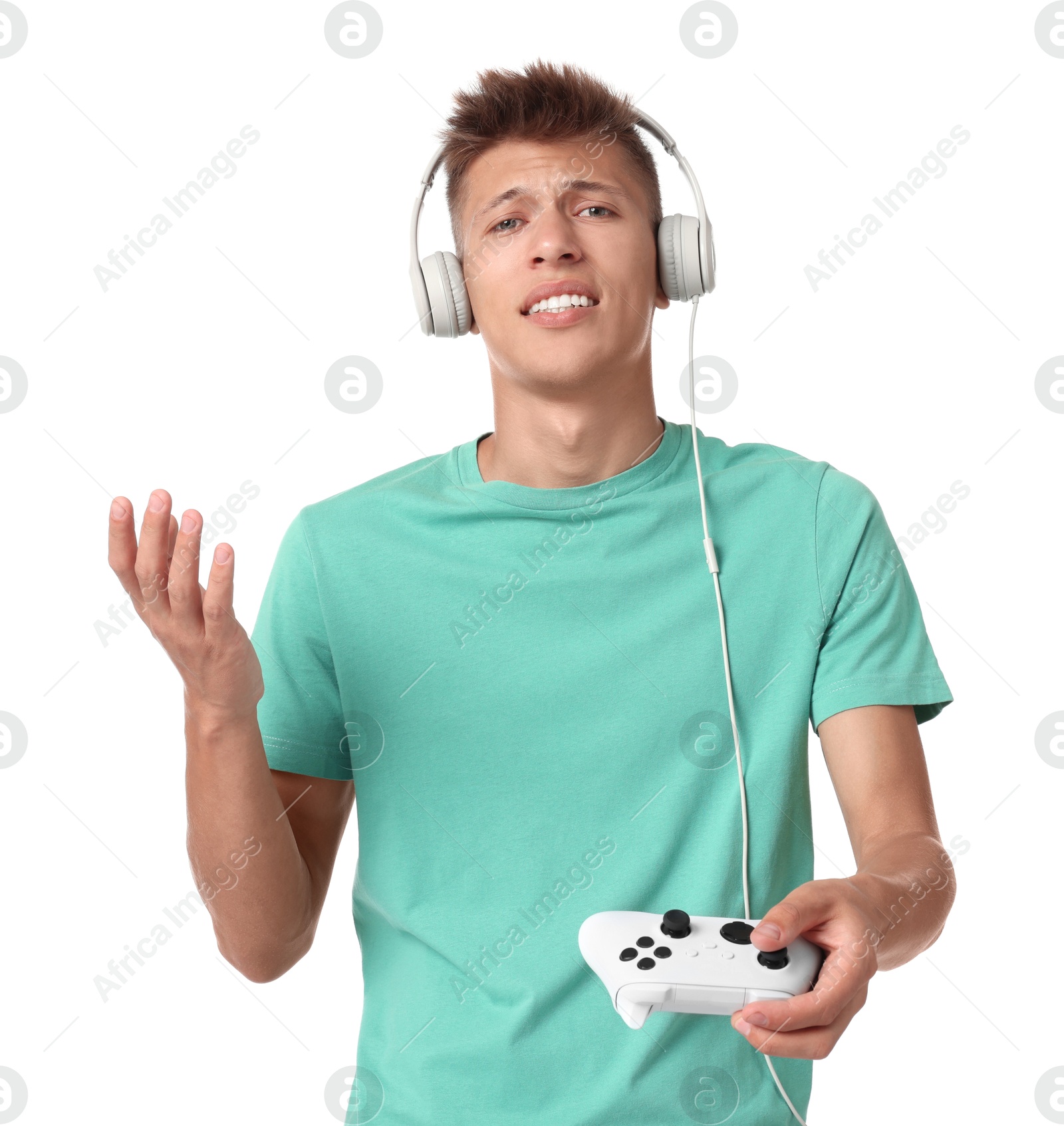 Photo of Unhappy young man in headphones with controller on white background