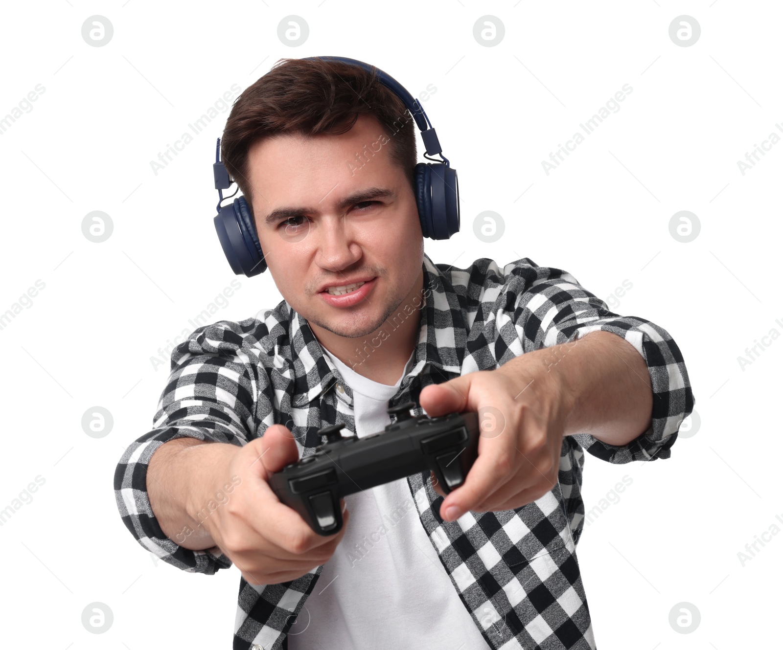 Photo of Young man in headphones playing video games with controller on white background