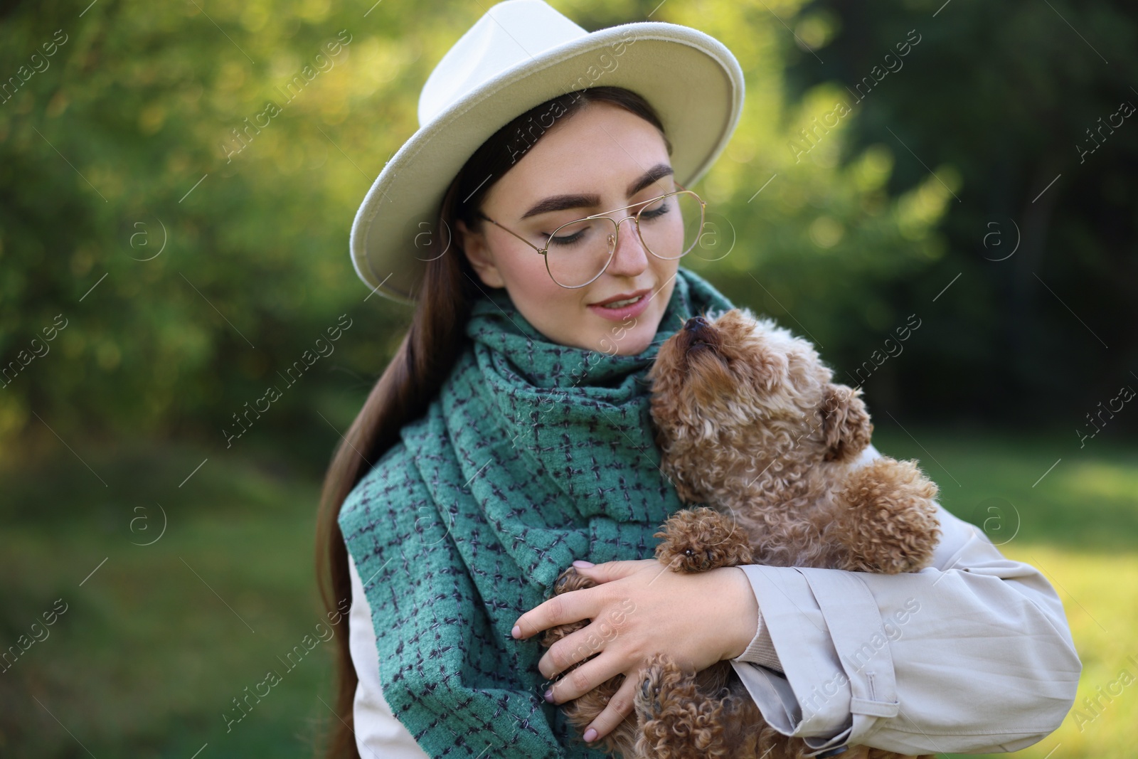 Photo of Woman with cute dog in autumn park