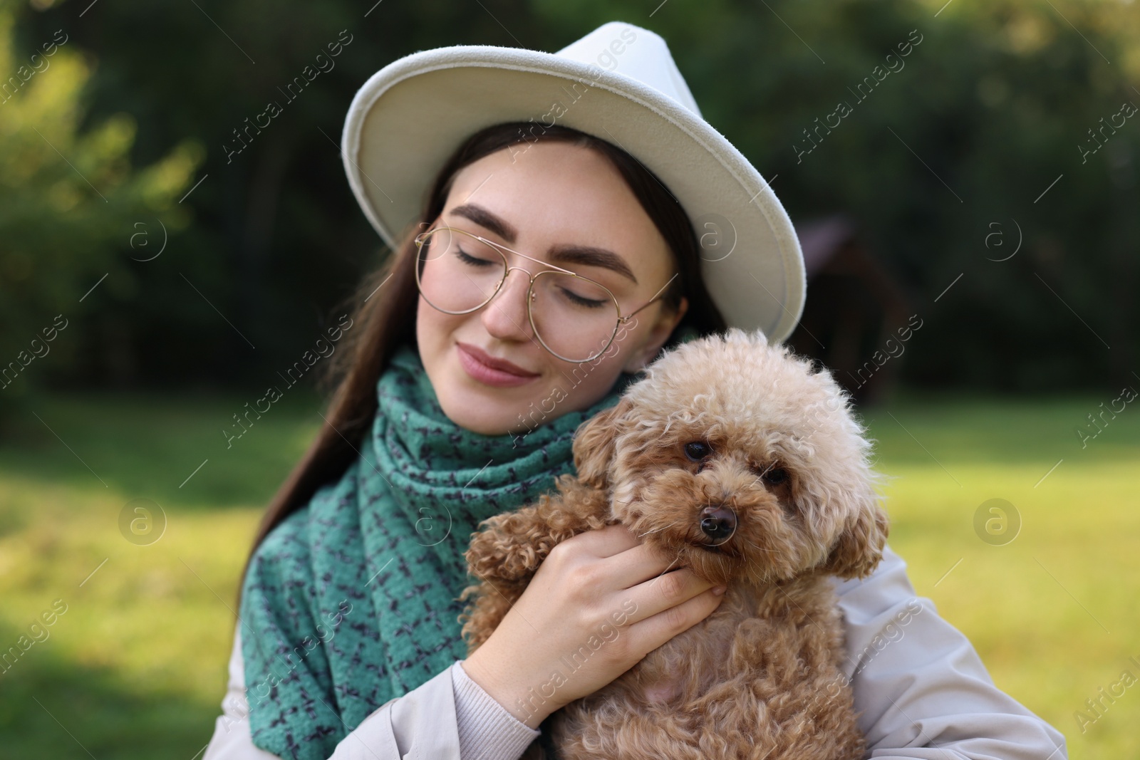 Photo of Woman with cute dog in autumn park