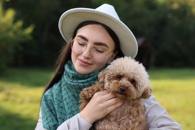 Photo of Woman with cute dog in autumn park