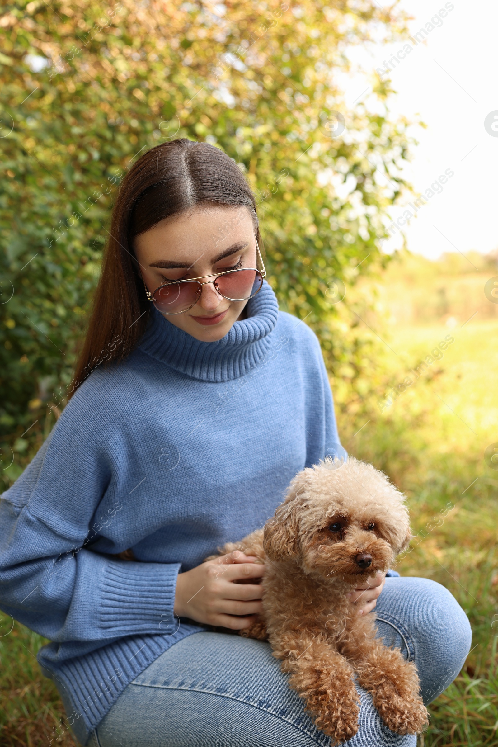 Photo of Woman with cute dog in autumn park