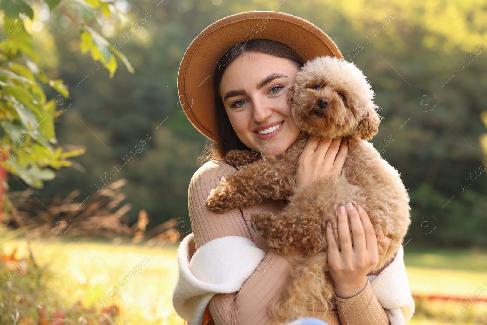 Photo of Smiling woman with cute dog outdoors on sunny day. Space for text