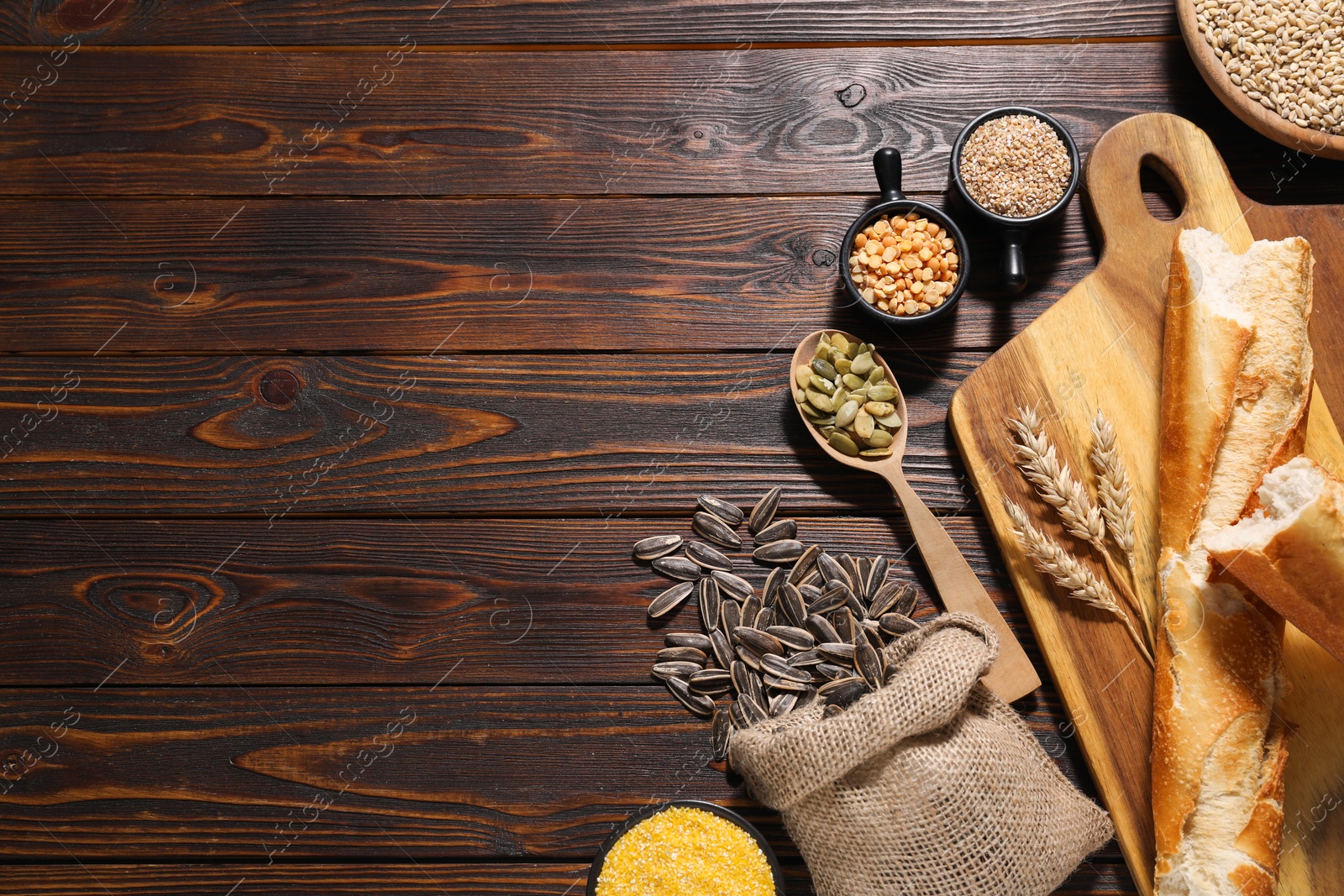 Photo of Different types of cereals, seeds and legumes on wooden table, flat lay. Space for text