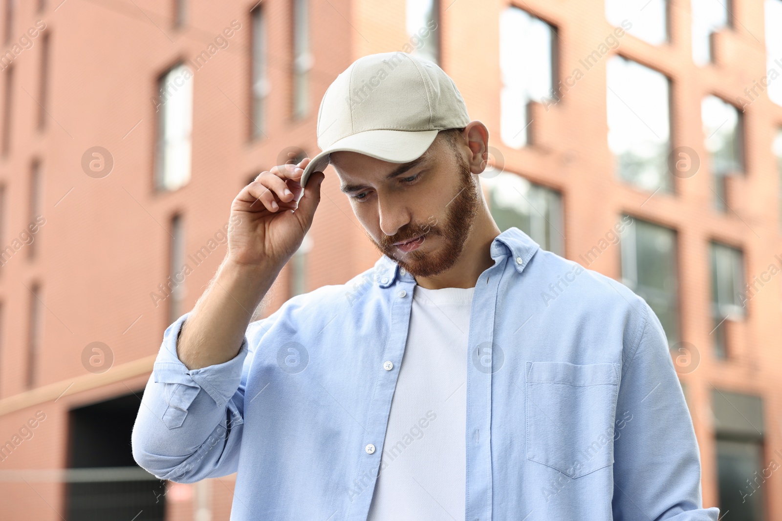 Photo of Portrait of handsome man in baseball cap outdoors